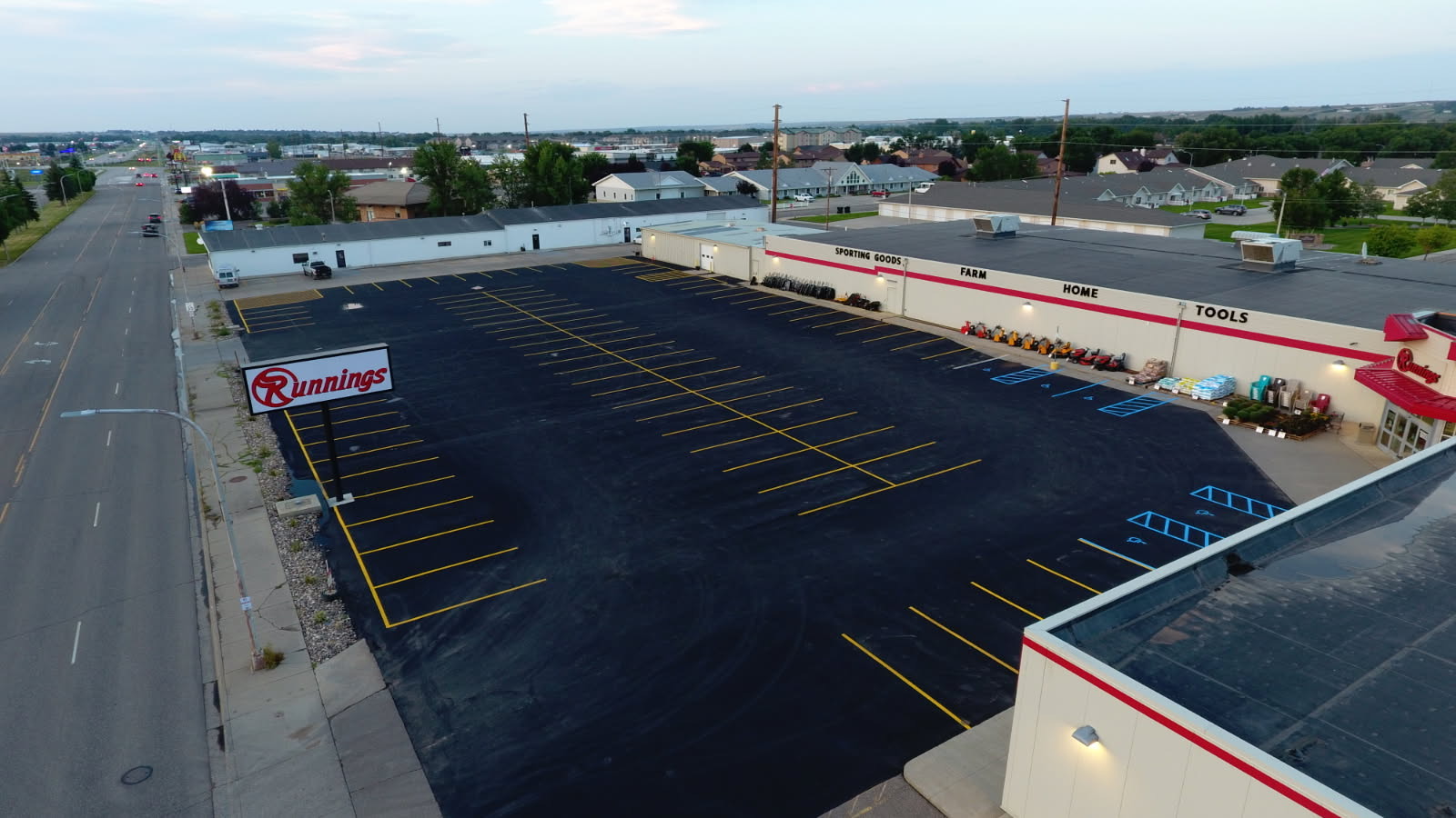 Freshly paved and striped Runnings retail parking lot in Williston, ND